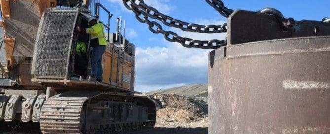 Construction crew operating heavy equipment on a job site using advanced ground improvement techniques and methods to enhance soil stability and foundation support.
