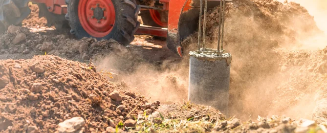 Dynamic compaction equipment compacting soil on a construction site, illustrating vibration monitoring and controlled soil densification for stable ground conditions.