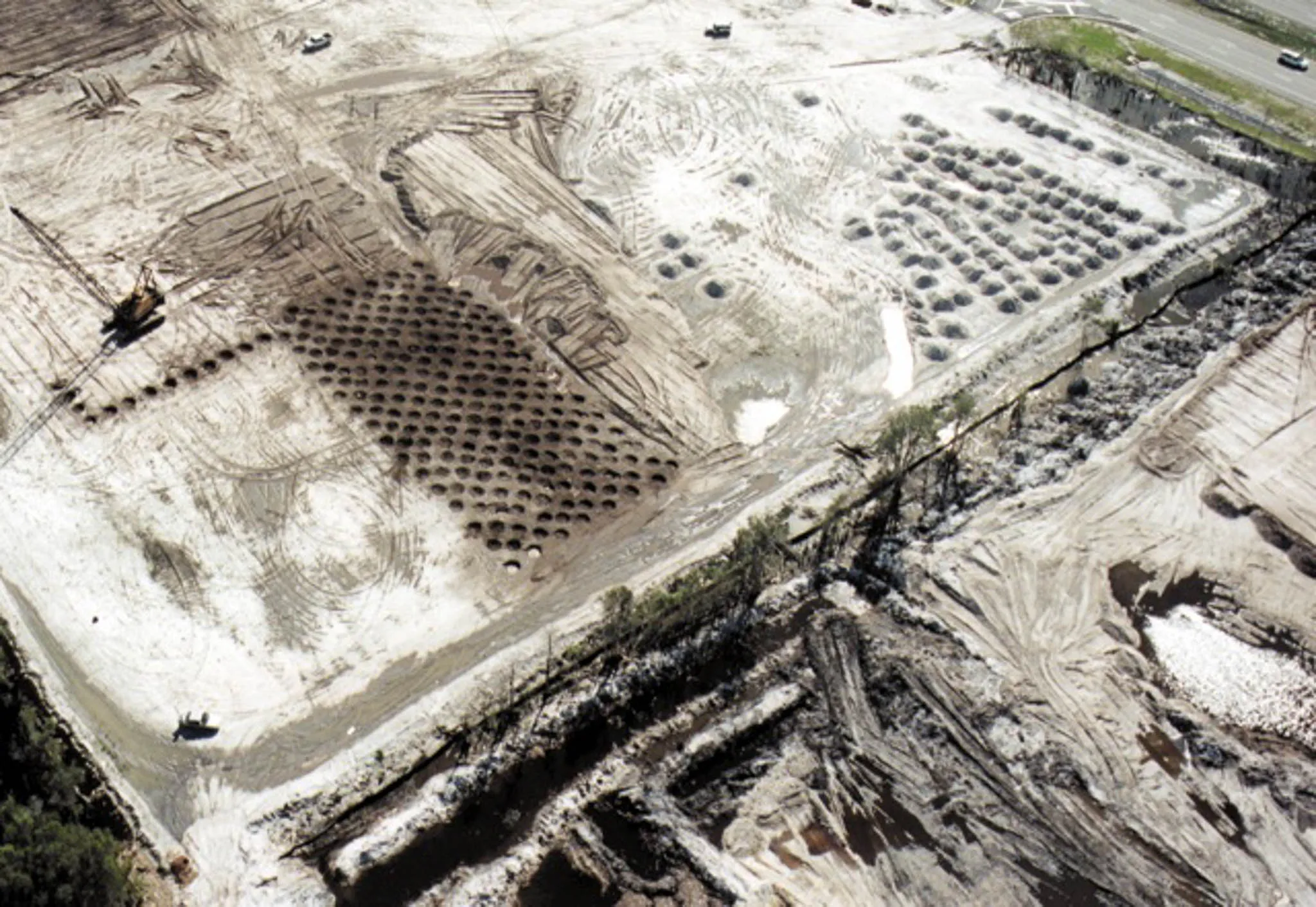 sand-site-compaction-grids-aerial-palm-beach-densification. Aerial of a white sand site in Palm Beach, Florida covered by multiple grids of compaction craters